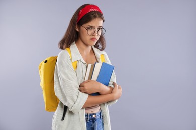 Photo of Student worried about her exam result on gray background. Space for text