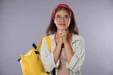 Photo of Student praying for good exam result on gray background