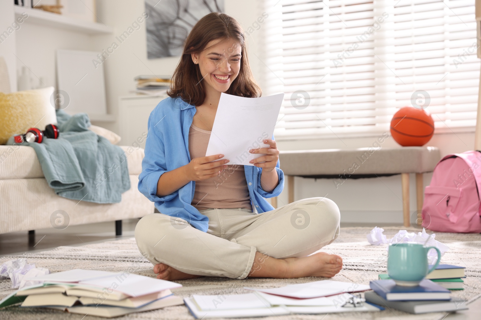 Happy student preparing for exam at home Photo of Happy student preparing for exam at home
