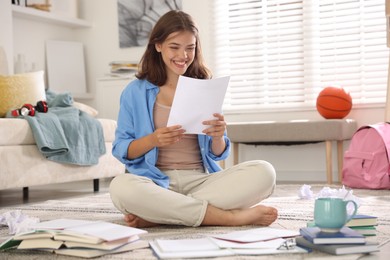 Photo of Happy student preparing for exam at home