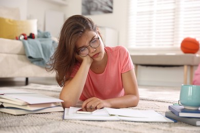 Photo of Tired student preparing for exam at home