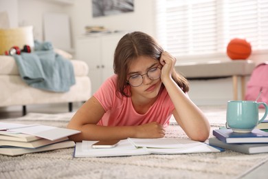 Photo of Tired student preparing for exam at home