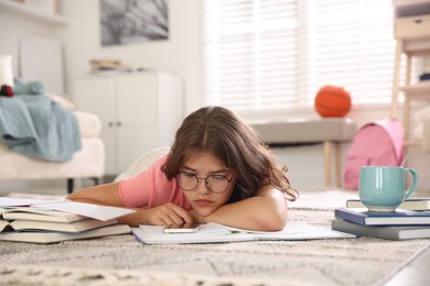 Photo of Tired student preparing for exam at home