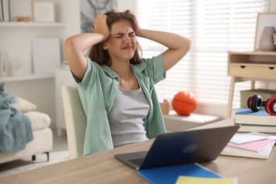 Photo of Stressed student preparing for exam at home