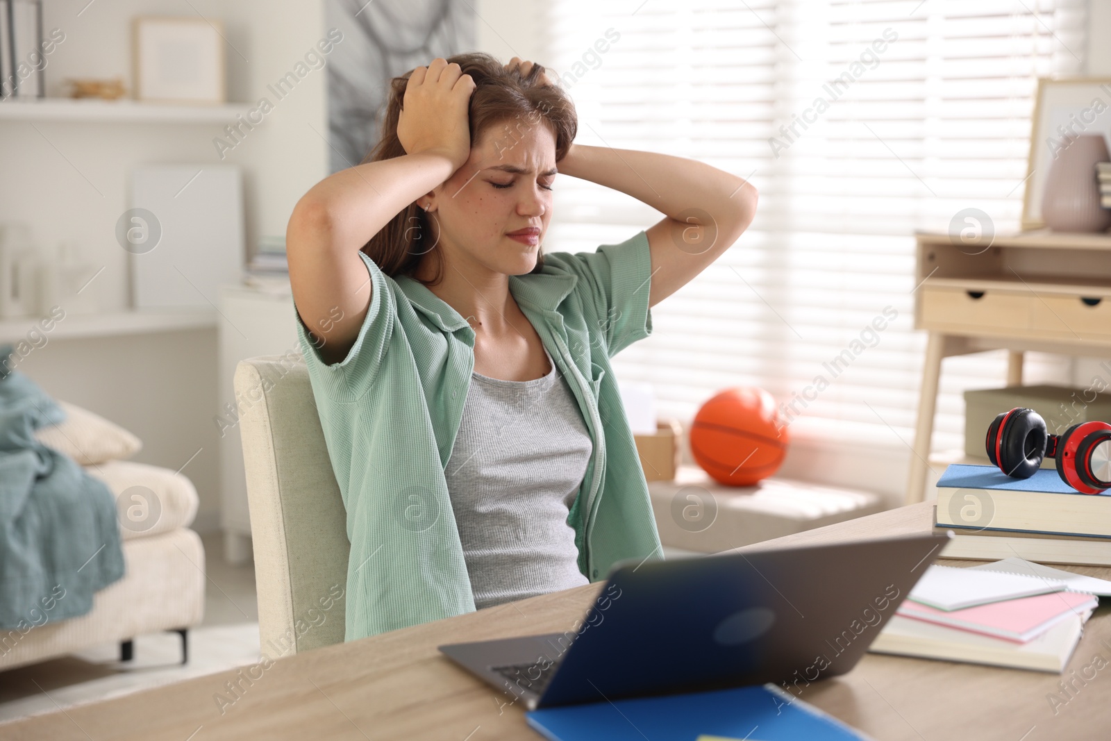 Stressed student preparing for exam at home Photo of Stressed student preparing for exam at home