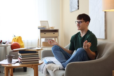 Photo of Student preparing for exam and meditating at home