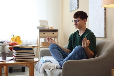 Photo of Student preparing for exam and meditating at home