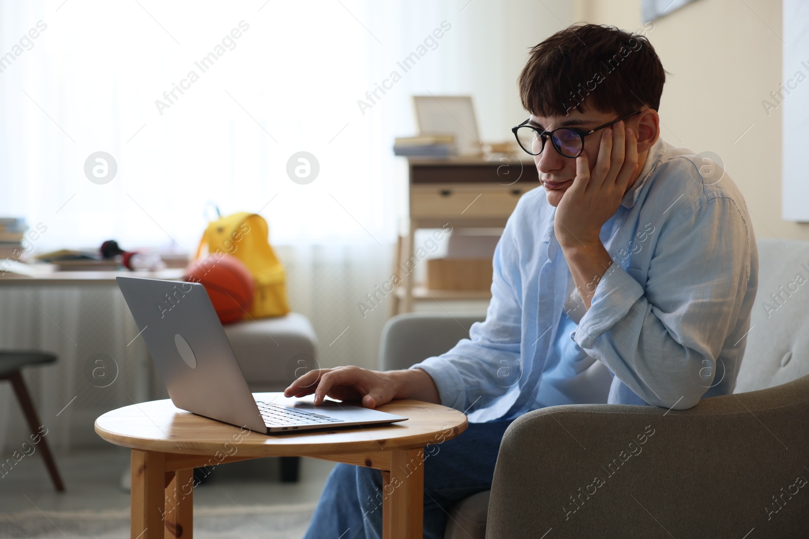 Tired student preparing for exam at table indoors Photo of Tired student preparing for exam at table indoors