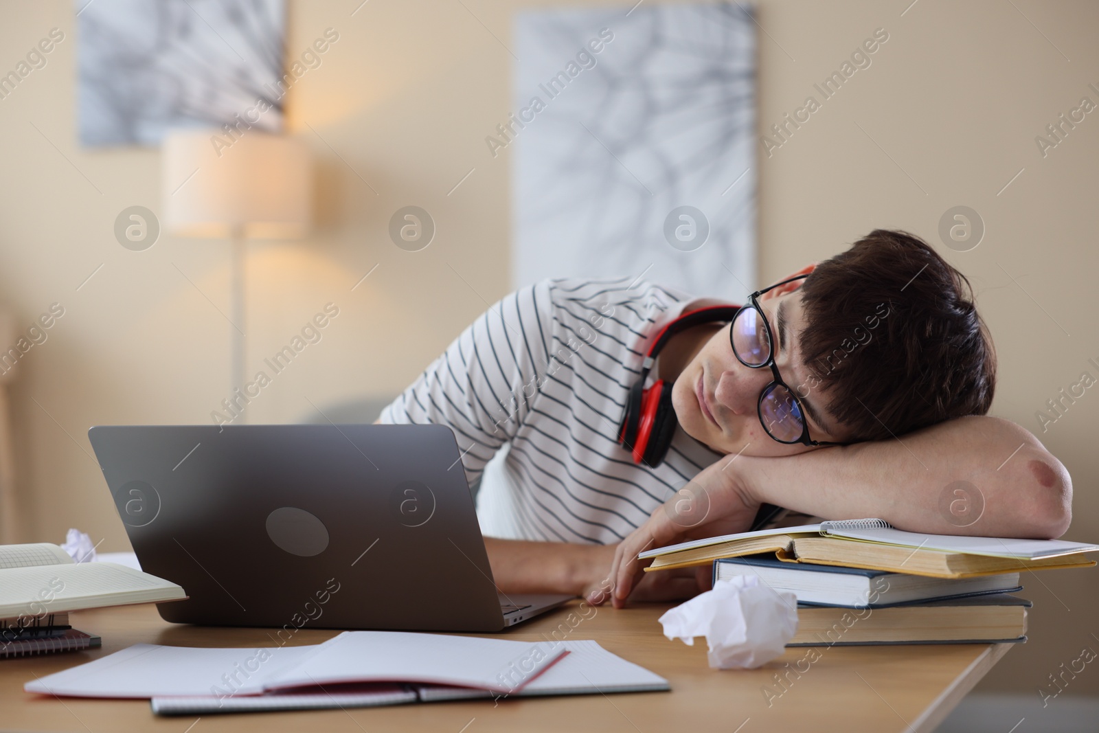 Worried student preparing for exam at table indoors Photo of Worried student preparing for exam at table indoors