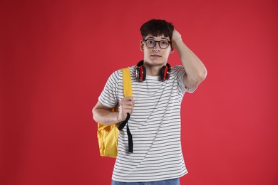 Photo of Student worried about his exam result on red background