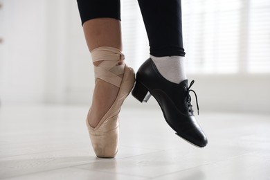 Photo of Teenage girl in tap and pointe shoe indoors, closeup
