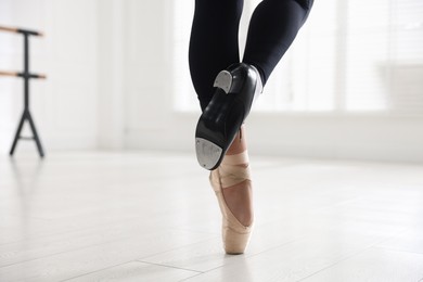 Photo of Teenage girl in tap and pointe shoe indoors, closeup