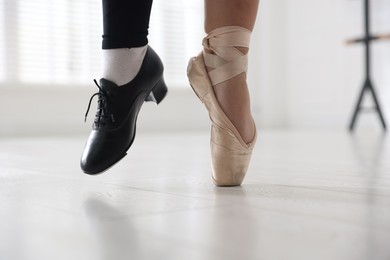 Photo of Teenage girl in tap and pointe shoe indoors, closeup
