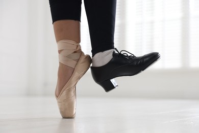 Photo of Teenage girl in tap and pointe shoe indoors, closeup