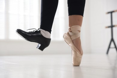 Photo of Teenage girl in tap and pointe shoe indoors, closeup