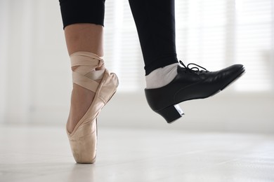 Photo of Teenage girl in tap and pointe shoe indoors, closeup