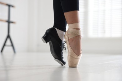 Photo of Teenage girl in tap and pointe shoe indoors, closeup