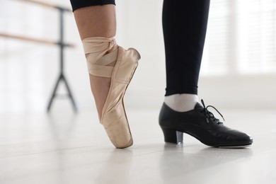 Photo of Teenage girl in tap and pointe shoe indoors, closeup