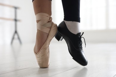 Photo of Teenage girl in tap and pointe shoe indoors, closeup