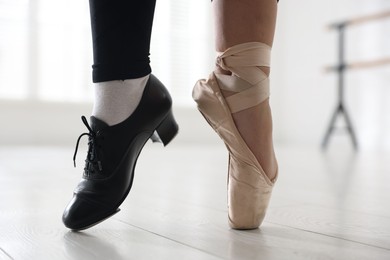 Photo of Teenage girl in tap and pointe shoe indoors, closeup