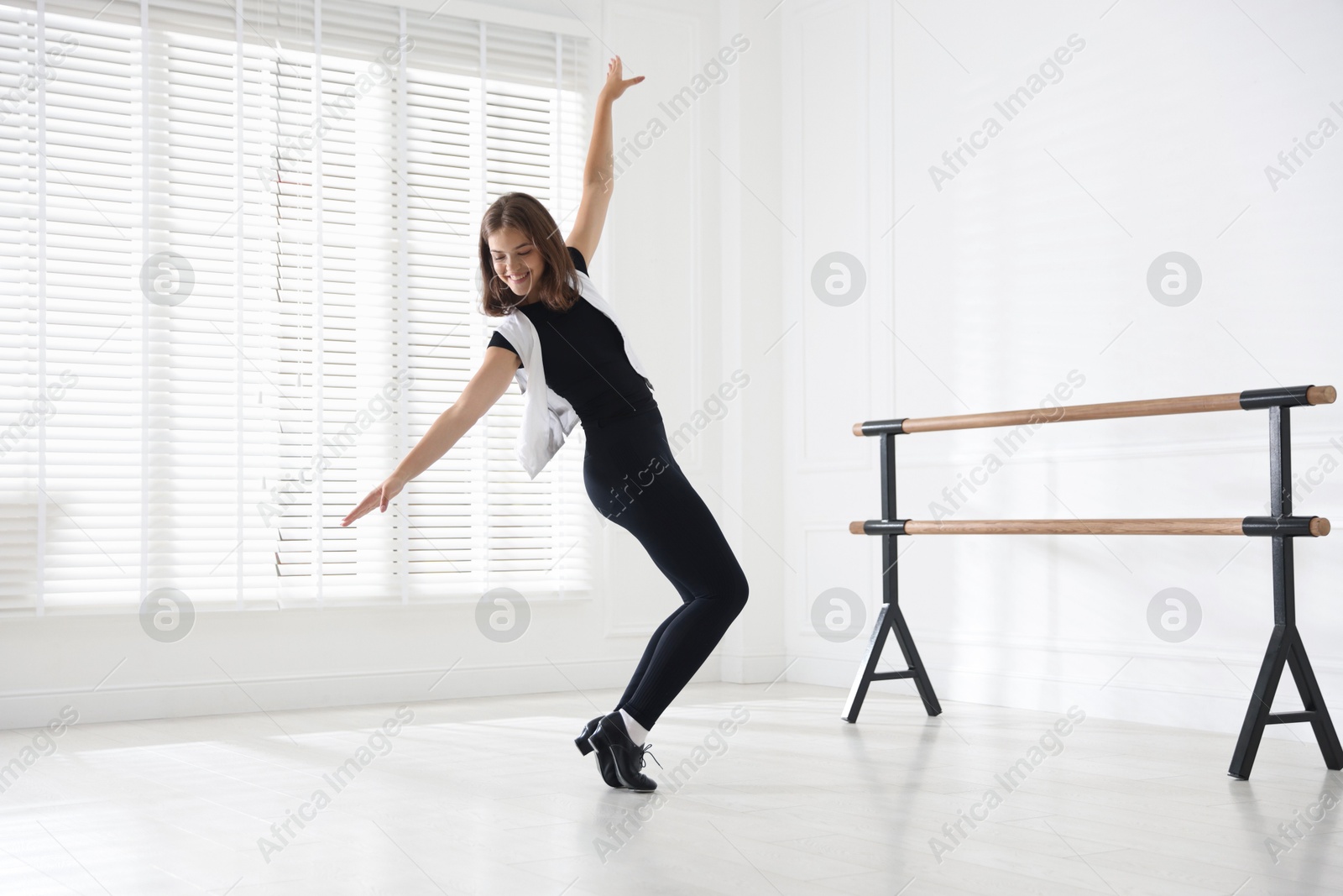 Teenage girl in tap shoes dancing indoors Photo of Teenage girl in tap shoes dancing indoors