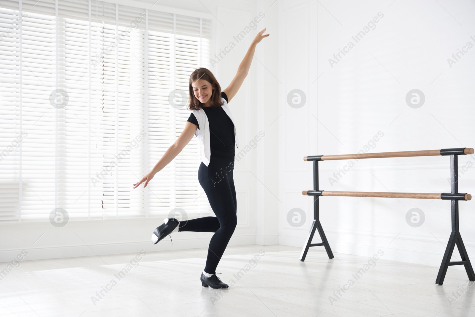 Teenage girl in tap shoes dancing indoors Photo of Teenage girl in tap shoes dancing indoors