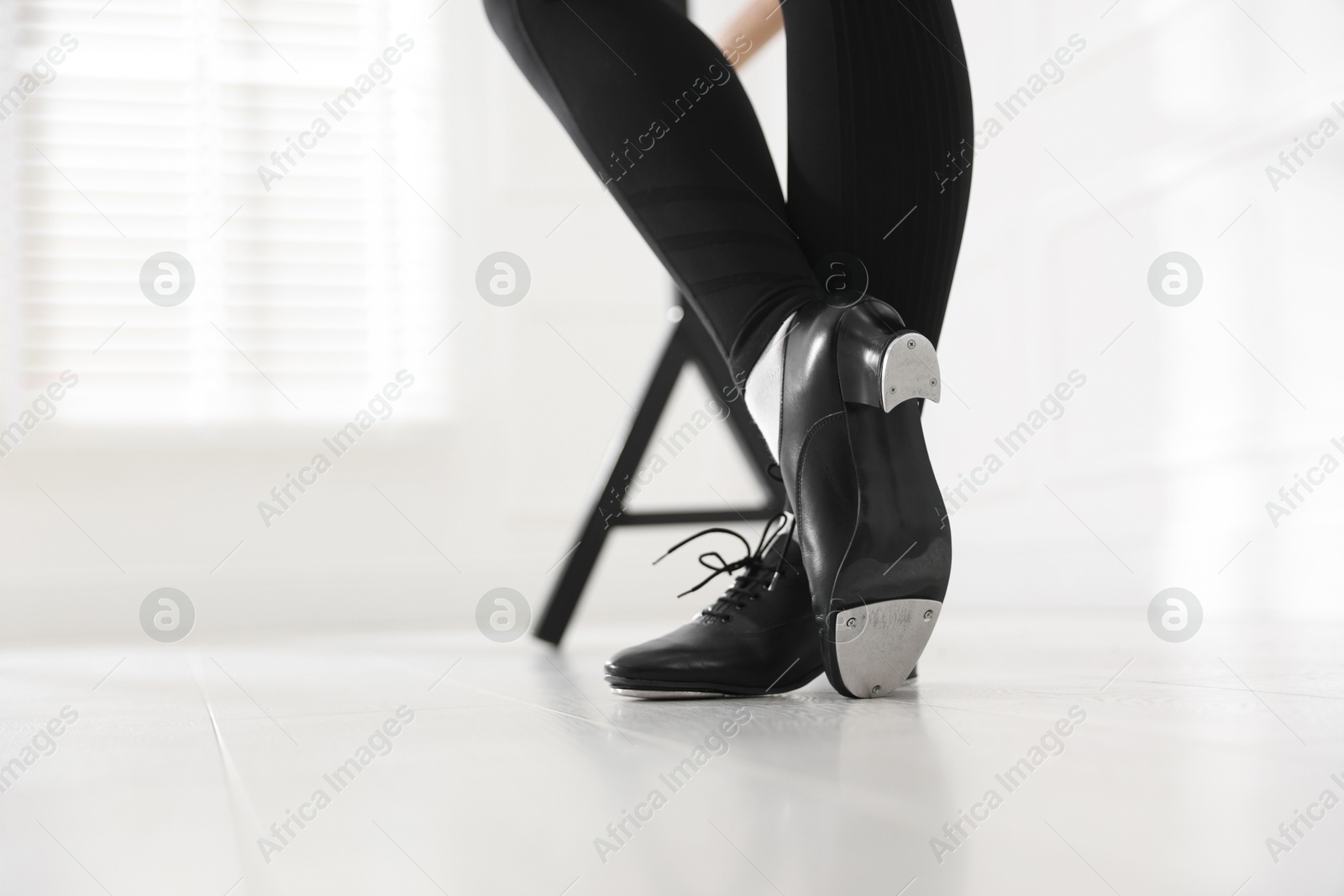 Photo of Teenage girl in tap shoes indoors, closeup