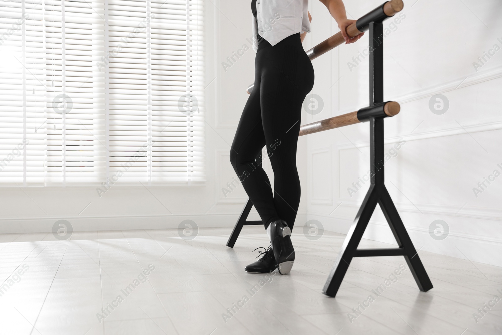 Photo of Teenage girl in tap shoes indoors, closeup
