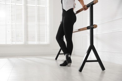 Photo of Teenage girl in tap shoes indoors, closeup
