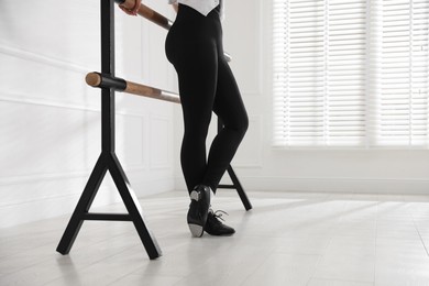 Photo of Teenage girl in tap shoes indoors, closeup