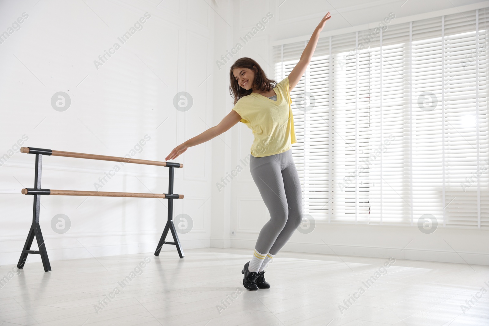 Teenage girl in tap shoes dancing indoors Photo of Teenage girl in tap shoes dancing indoors