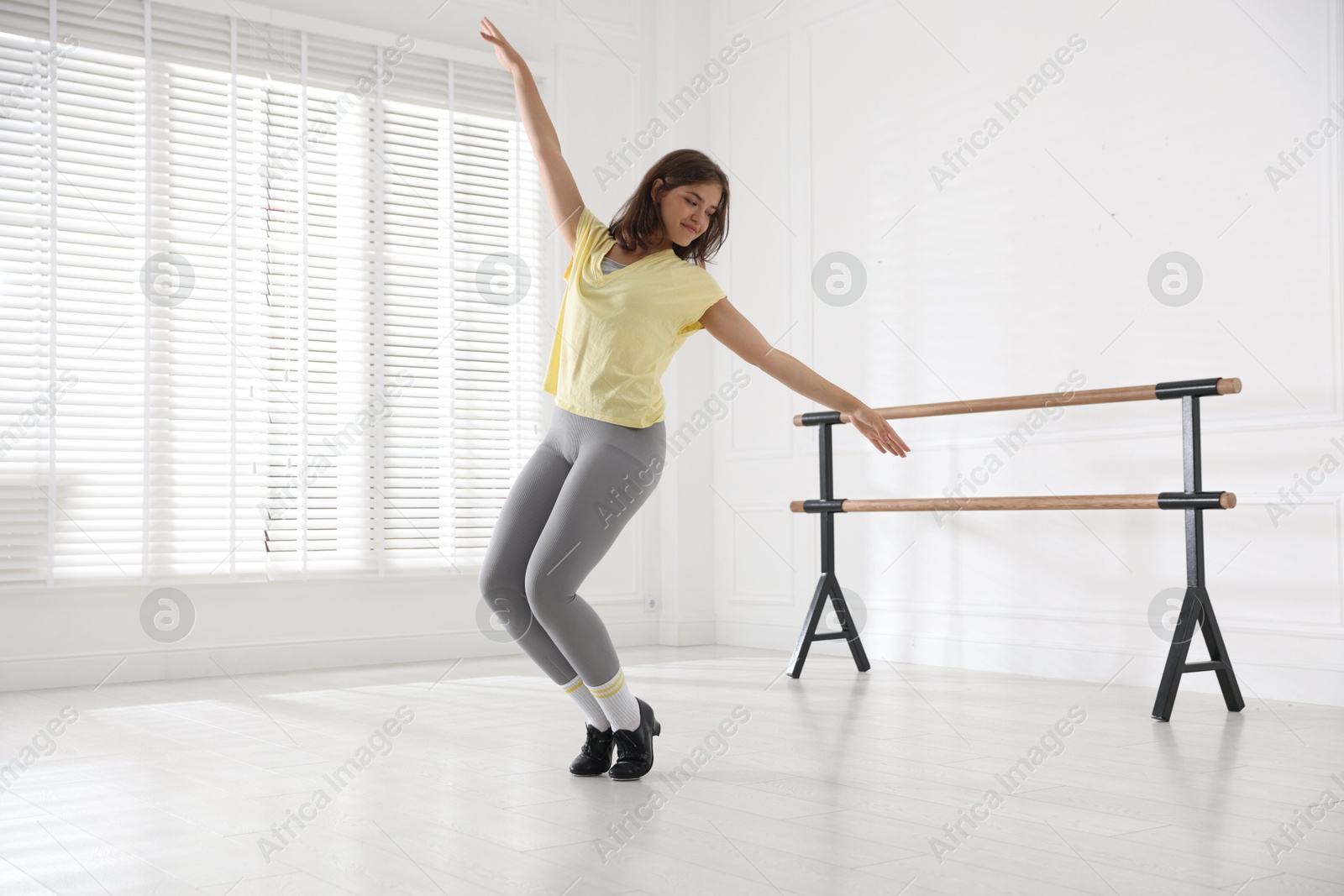 Teenage girl in tap shoes dancing indoors Photo of Teenage girl in tap shoes dancing indoors