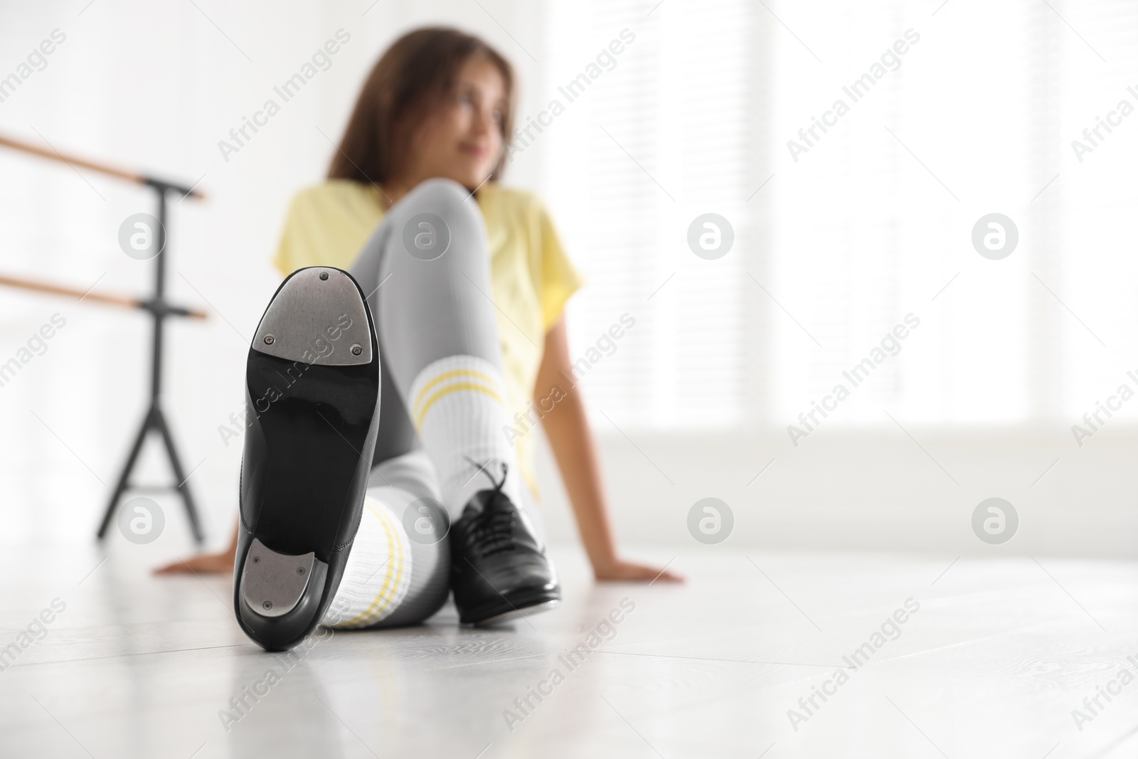 Teenage girl in tap shoes indoors, selective focus. Space for text Photo of Teenage girl in tap shoes indoors, selective focus. Space for text