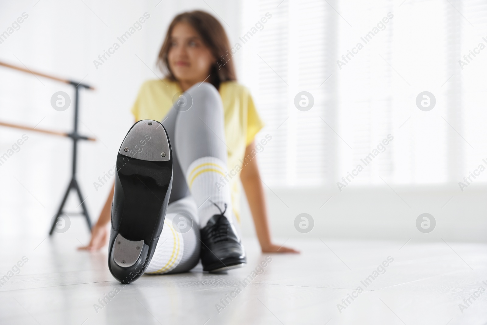 Teenage girl in tap shoes indoors, selective focus. Space for text Photo of Teenage girl in tap shoes indoors, selective focus. Space for text