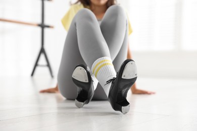 Photo of Teenage girl in tap shoes indoors, closeup