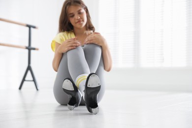 Photo of Teenage girl in tap shoes indoors, selective focus