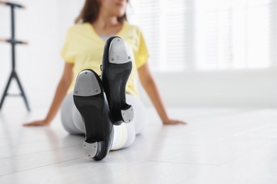 Photo of Teenage girl in tap shoes indoors, closeup