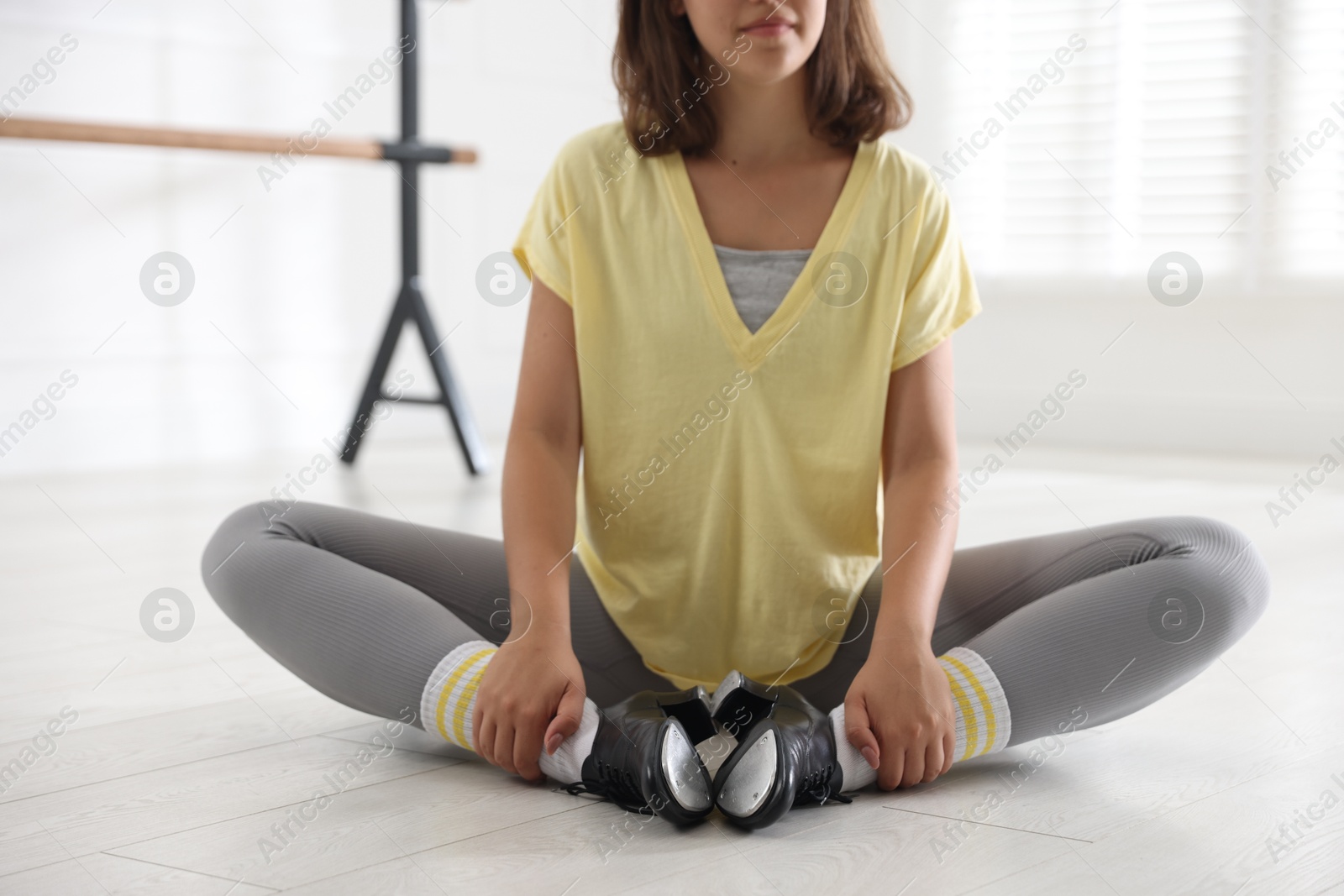 Teenage girl in tap shoes indoors, closeup Photo of Teenage girl in tap shoes indoors, closeup