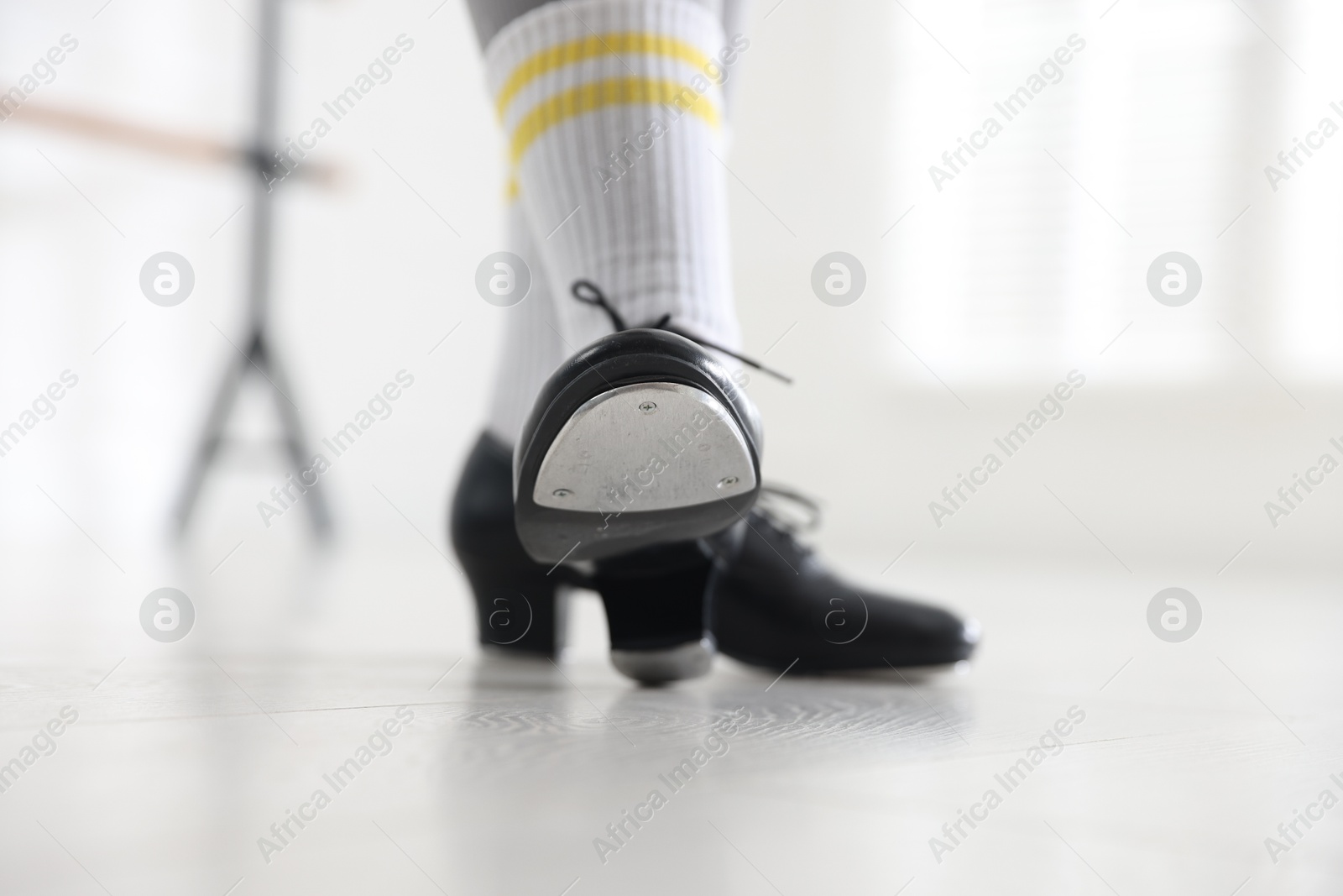 Photo of Teenage girl in tap shoes indoors, closeup