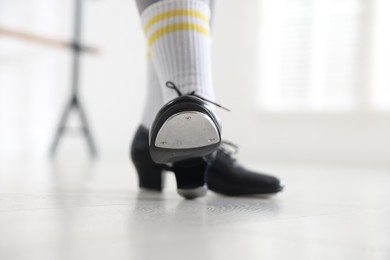 Photo of Teenage girl in tap shoes indoors, closeup