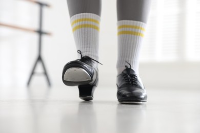 Photo of Teenage girl in tap shoes indoors, closeup