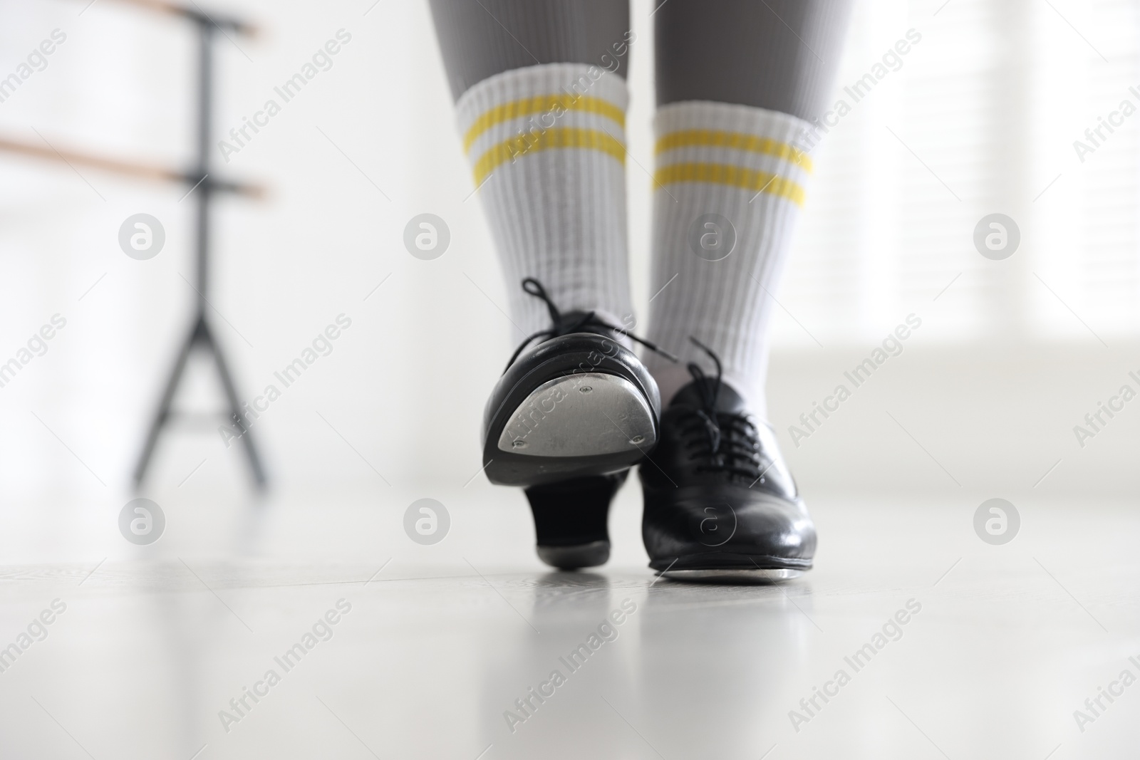 Photo of Teenage girl in tap shoes indoors, closeup