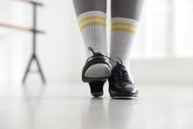Photo of Teenage girl in tap shoes indoors, closeup