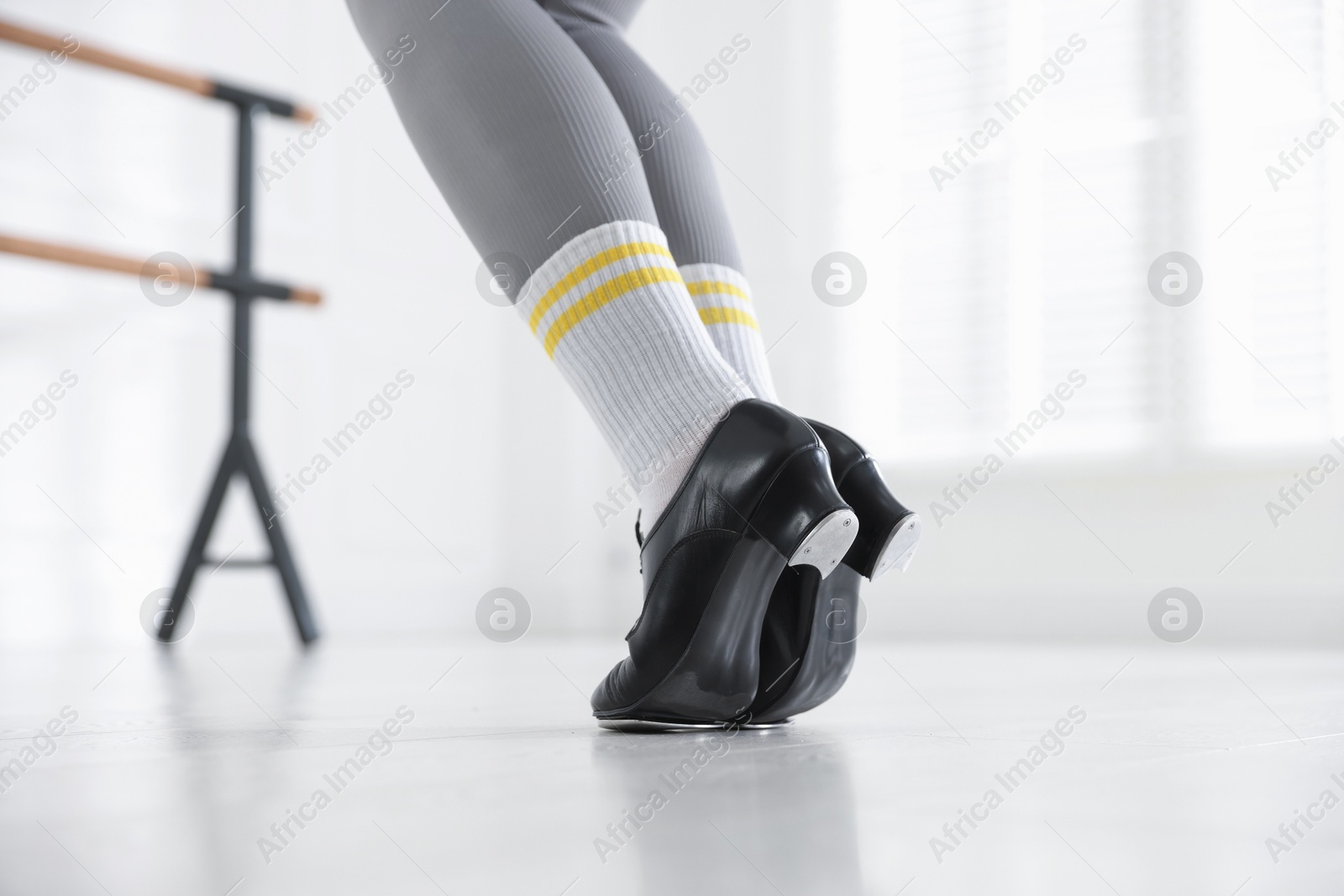 Photo of Teenage girl in tap shoes indoors, closeup