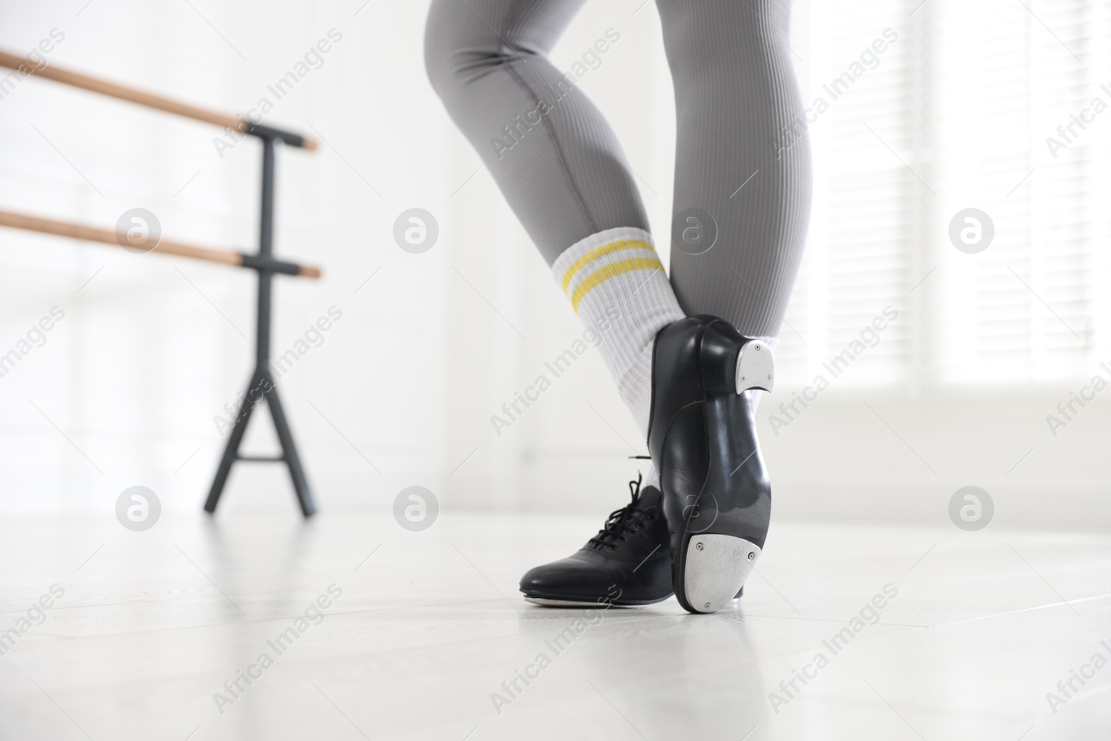 Photo of Teenage girl in tap shoes indoors, closeup
