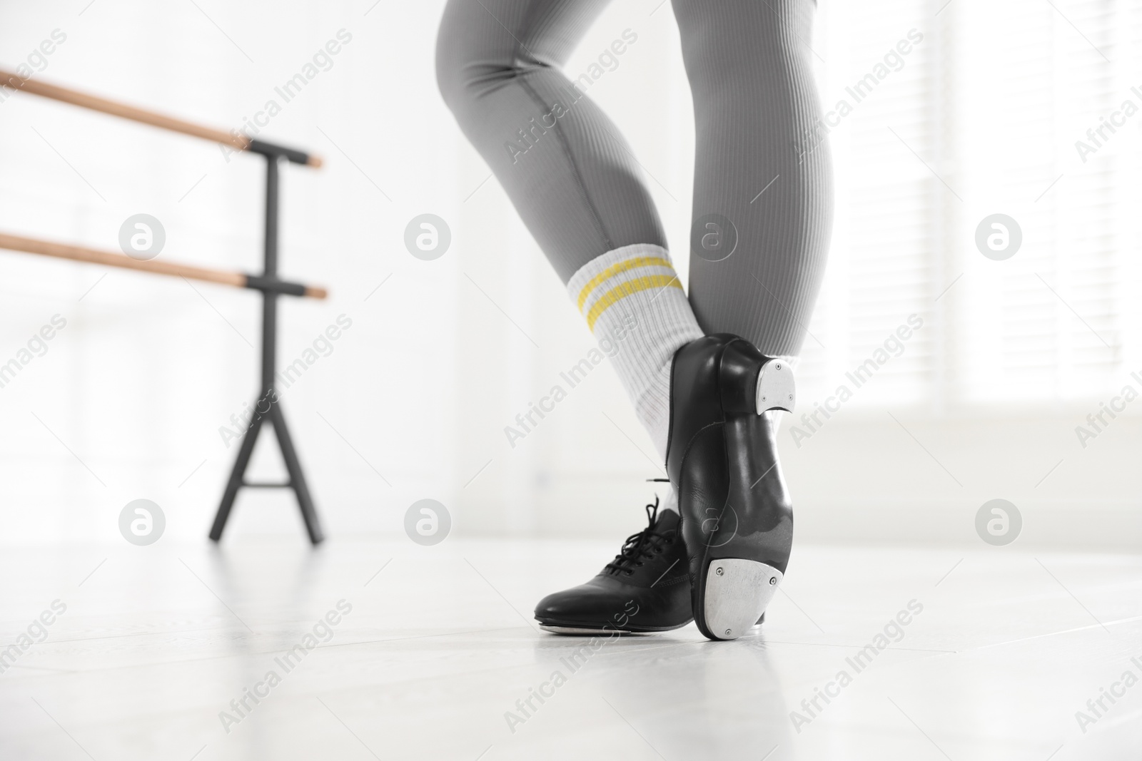Photo of Teenage girl in tap shoes indoors, closeup
