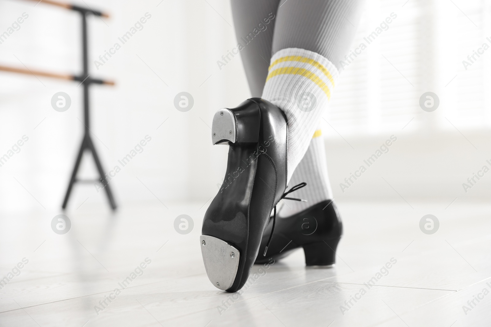 Photo of Teenage girl in tap shoes indoors, closeup