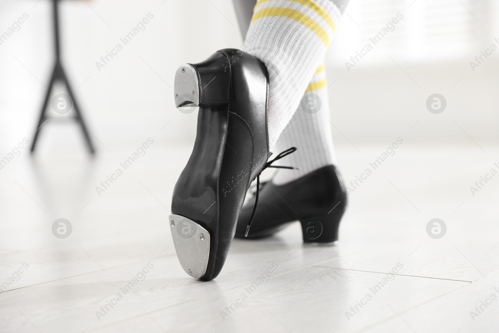 Photo of Teenage girl in tap shoes indoors, closeup