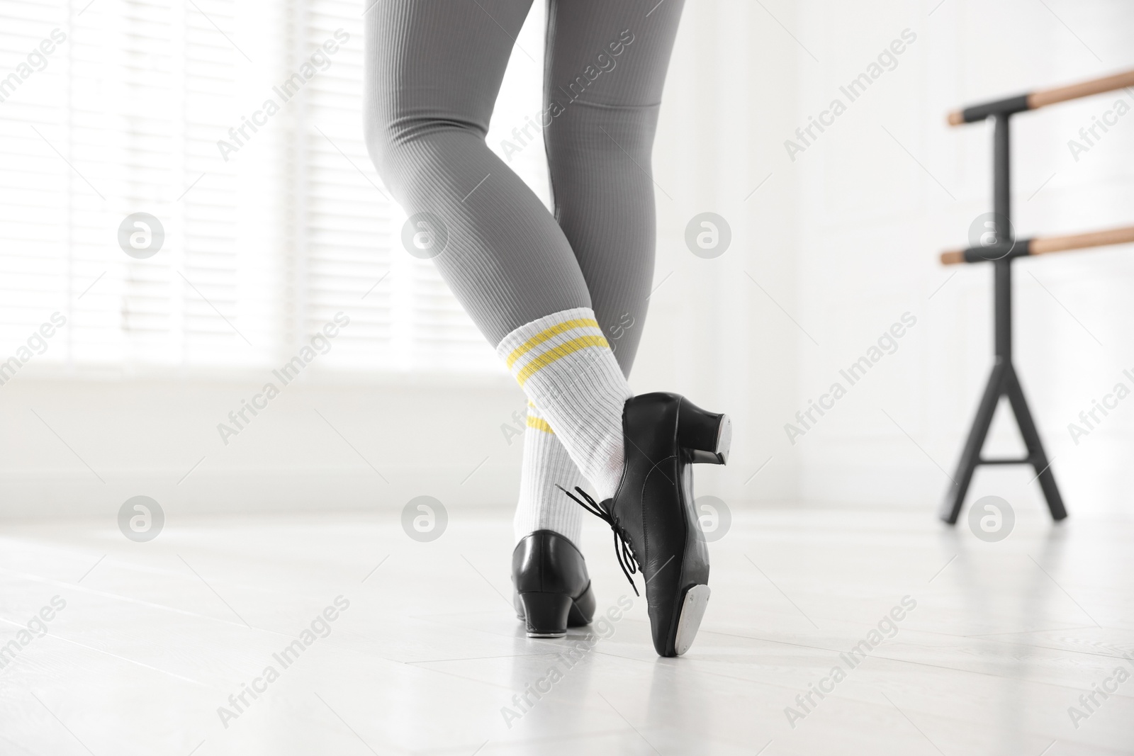 Photo of Teenage girl in tap shoes indoors, closeup