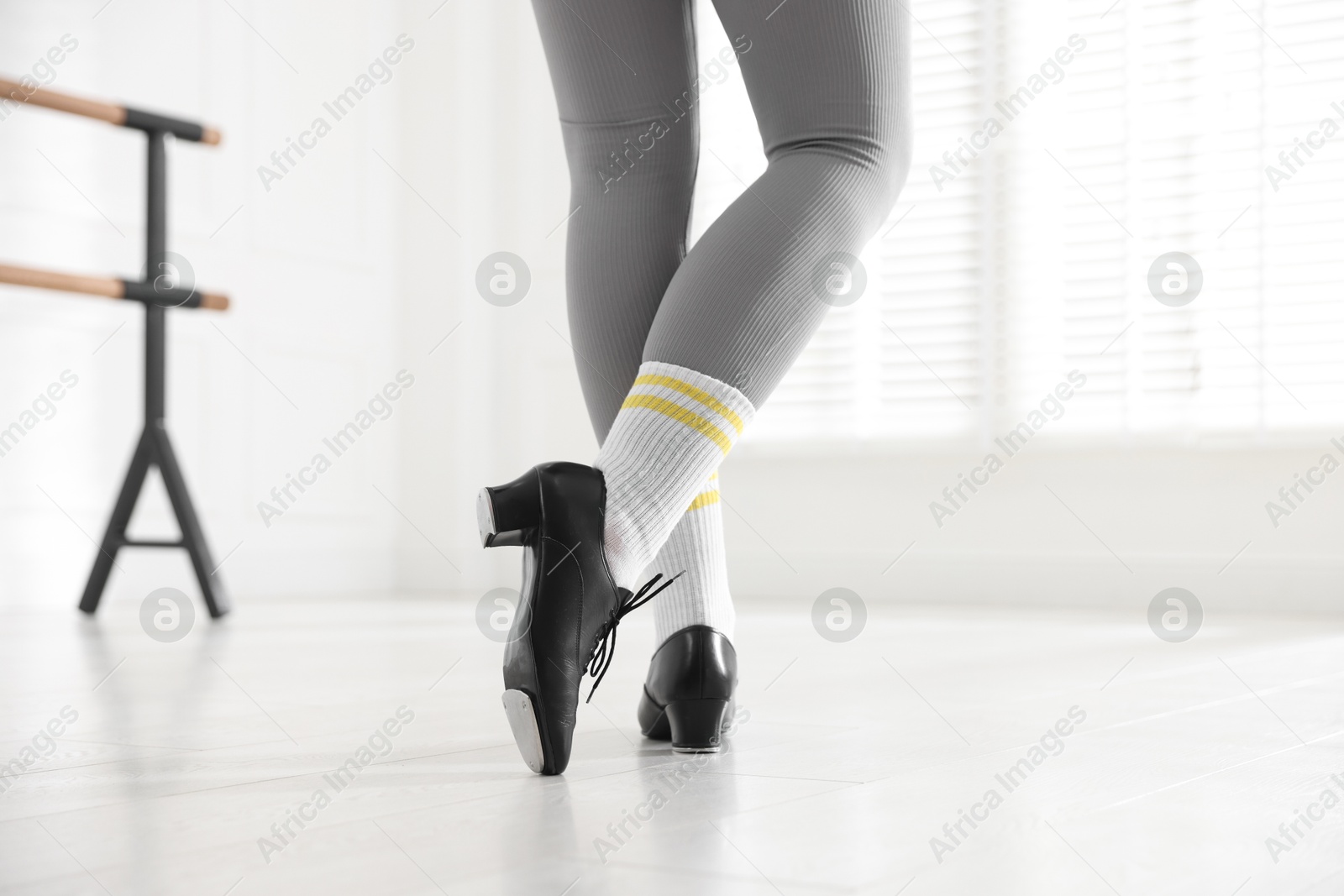 Photo of Teenage girl in tap shoes indoors, closeup